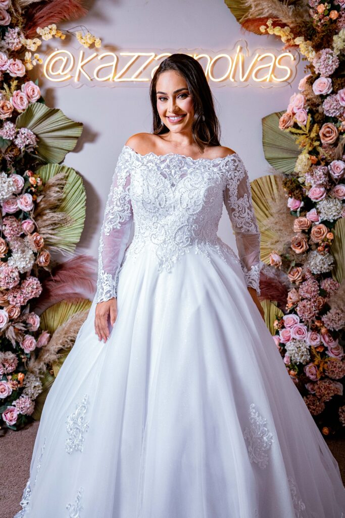 Vestido de Noiva Princesa com Gola Canoa, Manga Longa em Renda Bordada e Saia Rodada com Aplicações de Renda